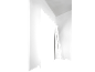 Minimalist interior with white walls and black shadows creating geometric shapes.