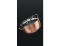 Copper-colored pot with a lid and stainless steel handles.