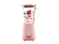 Pink blender with a glass jug filled with berries and yogurt.