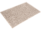 Beige looped texture bath mat on a black background.
