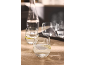 Water carafe and glasses of water with lemon slices on a table.