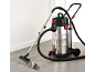 Stainless steel wet and dry vacuum cleaner with a water spill on the floor.