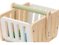 Wooden toy shopping basket with a light green handle and white slatted sides.