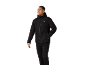 Man in black sports jacket and trousers, smiling and looking to the right.