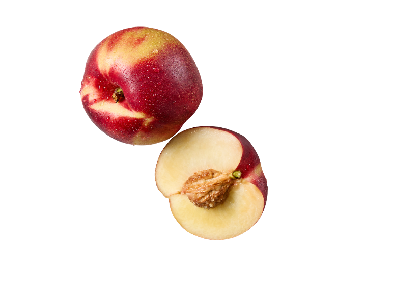 Whole and halved nectarine with water droplets on a black background.