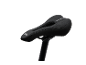 Black bicycle saddle with a cutout and perforations, mounted on a seat post.