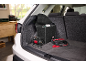 Car compressor and portable jump starter in a car trunk, with a trunk organizer.