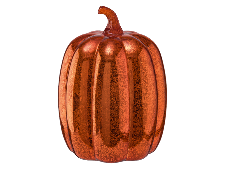 Decorative orange glass pumpkin with a shimmering effect on a black background.
