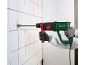 Man demolishing tiles with a hammer drill and chisel