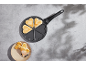 Pan with heart-shaped pancakes and a plate with decorated pancakes
