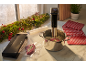 Vacuum sealer and sous vide cooker preparing meat, with festive holiday decor.