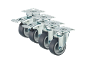 Four grey and silver caster wheels, two with brakes, arranged diagonally.