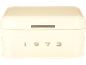 Cream bread bin with a slot and embossed numbers '1973'.