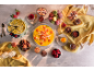 Table laden with desserts: cakes, macarons, fruits, and creams.