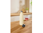 Beige water bottle and tea cup on a wooden kitchen countertop.