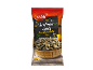 Bag of roasted and salted sunflower seeds with a bowl of seeds on wood.
