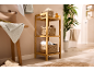 Bamboo bathroom shelf with woven baskets, towels, and a plant.