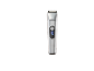 Silver hair trimmer with a digital display showing 100% charge.