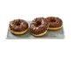 Three chocolate-glazed donuts with sprinkles on a rectangular grey plate.