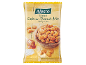 Roasted cashew-peanut mix with honey and salt, on a wooden background.