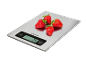 Digital kitchen scale with five strawberries, displaying a weight of 74 g.