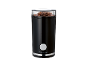 Black coffee grinder with coffee beans on top.
