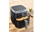 Black air fryer with a digital display showing '200' and a basket full of potato wedges.