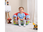 Toddler in a red and green inflatable armchair with cartoon dog characters.