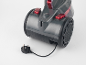 Grey cylinder vacuum cleaner with red buttons and a black UK plug.