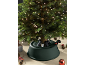 Lit Christmas tree with a green stand and festive decorations.