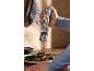 Hand grinding pepper over a steak and asparagus dish with an electric pepper mill.