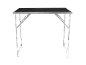 Foldable workbench with metal legs and a black work surface.