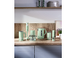 Mint green kitchen appliances, including a hand blender, kettle, and chopper, on a wooden counter.