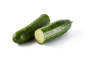 Two fresh cucumbers, one whole and one cut in half, with water droplets.