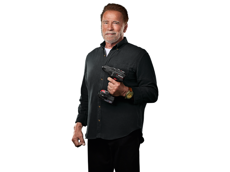 Bearded man in a dark shirt holding a cordless drill.