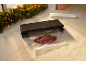 Vacuum sealer with meat and rosemary, Christmas garland in the background.