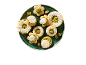 Pistachio cookies with powdered sugar on a green plate.