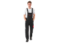 Smiling man in black work overalls and white T-shirt