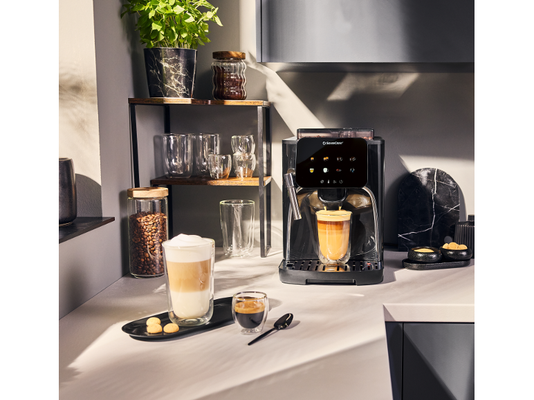 Coffee machine with a touchscreen display, preparing latte and espresso, in a modern kitchen.