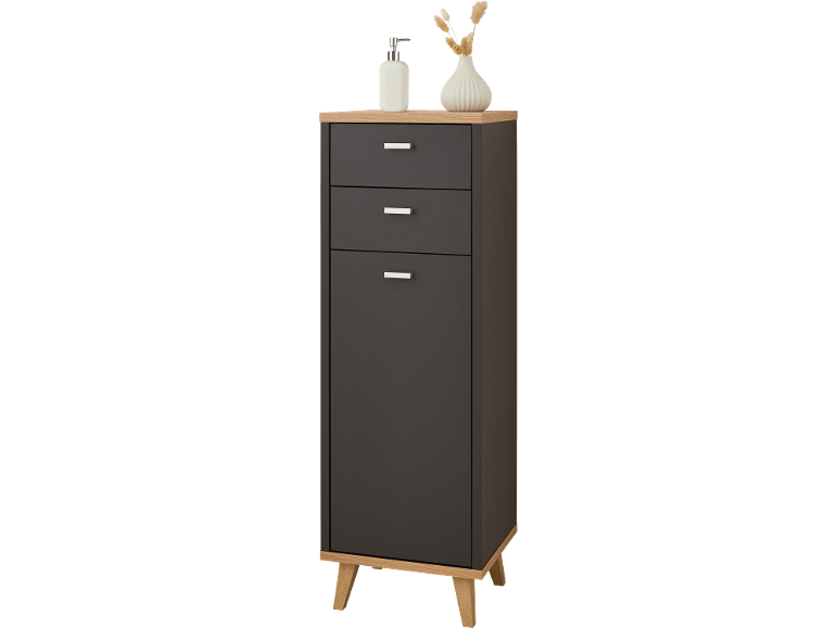 Grey bathroom chest of drawers with three drawers and a door, topped with a soap dispenser and a vase.