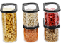 Transparent food storage containers with pasta, oats, lentils, dried strawberries, and granola.