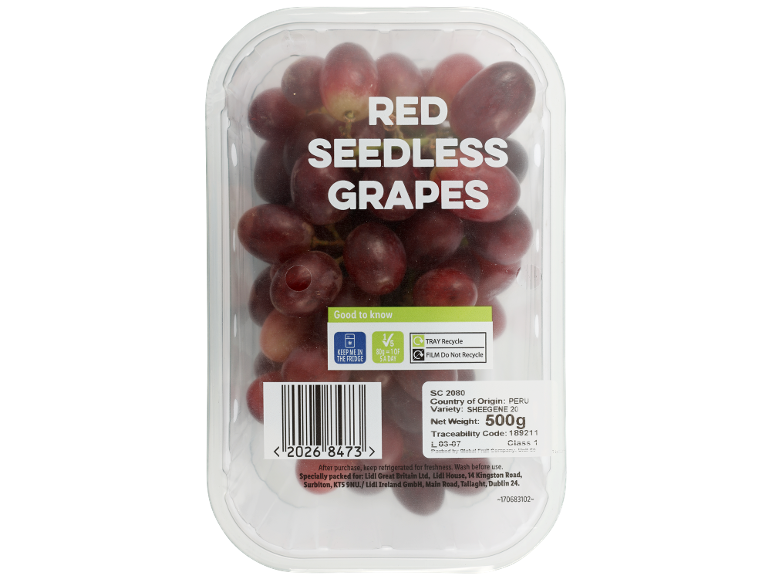 Red seedless grapes in a clear plastic container, with nutritional and recycling information.