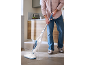 Man cleaning kitchen floor with a steam mop.