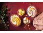 Four desserts, including two ice creams in tubs, on a red background with Christmas decorations.