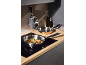 Stainless steel frying pans with food on an induction hob in a modern kitchen.