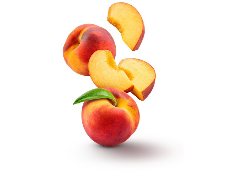 Peaches and peach slices with a leaf, falling against a white background.