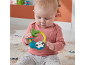Baby playing with a brightly colored sloth rattle.