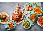 A feast of roasted lamb dishes, including a whole leg, rack, and sliced shoulder, with sides.
