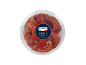 Round transparent container of marinated semi-dried tomatoes
