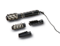 Black hot air styler with multiple brush attachments and a concentrator.